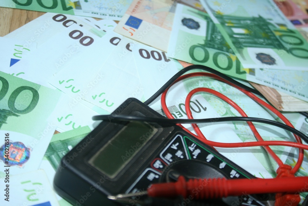 Multimeter on the euro banknotes background. The concept of electricity and electricity bills. Multimeter on the euro banknotes background. The concept of electricity and electricity bills.