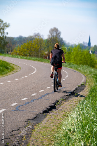 One woman ride bicycle in Betuwe, Gelderland, Netherlands