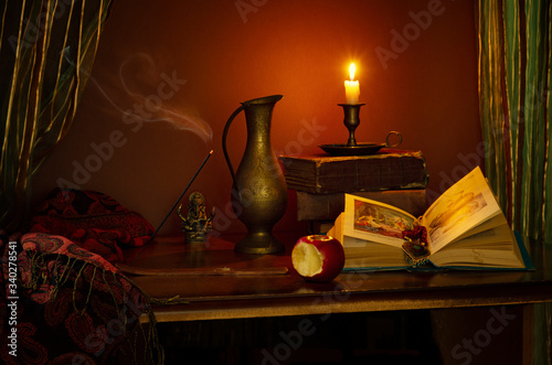 Still life, art, Indian motif, books, candle, apple, jewelry, bronze jug.
