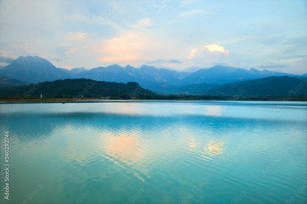 calm lake in the mountains at sunset calm lake in the mountains at sunset