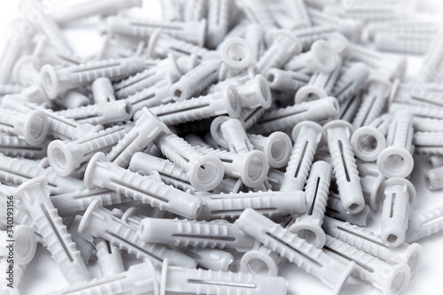 Lot of plastic dowels on a white background photo