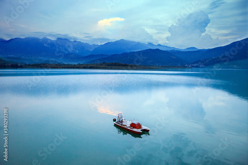 catamaran on the lake at sunset in the mountains