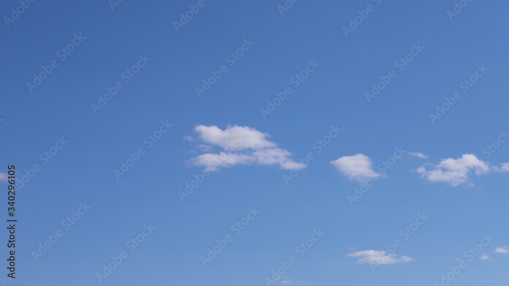 Spring blue sky with clouds. Background of blue sky and clouds. Spring blue sky with clouds. Background of blue sky and clouds.