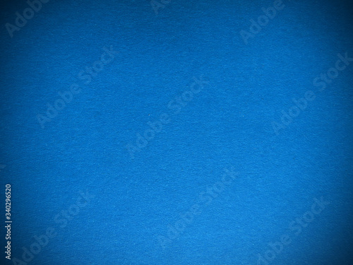 Blue paper texture. Beautiful blue background with darkened edges. Illustration can be used as background or layout