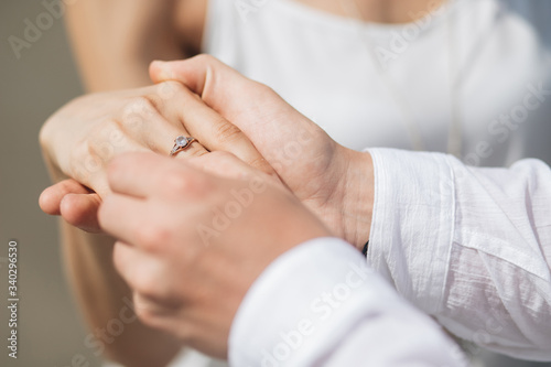 guy puts a ring on the girl   s hand