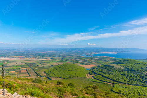 Alghero coastline under a blue sky in summertime