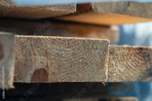 Wooden board in a pile of other boards with blur