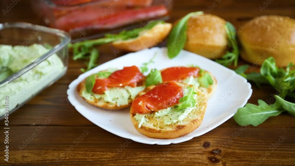 sandwich with fried bun, cheese spread and red fish in a plate sandwich with fried bun, cheese spread and red fish in a plate