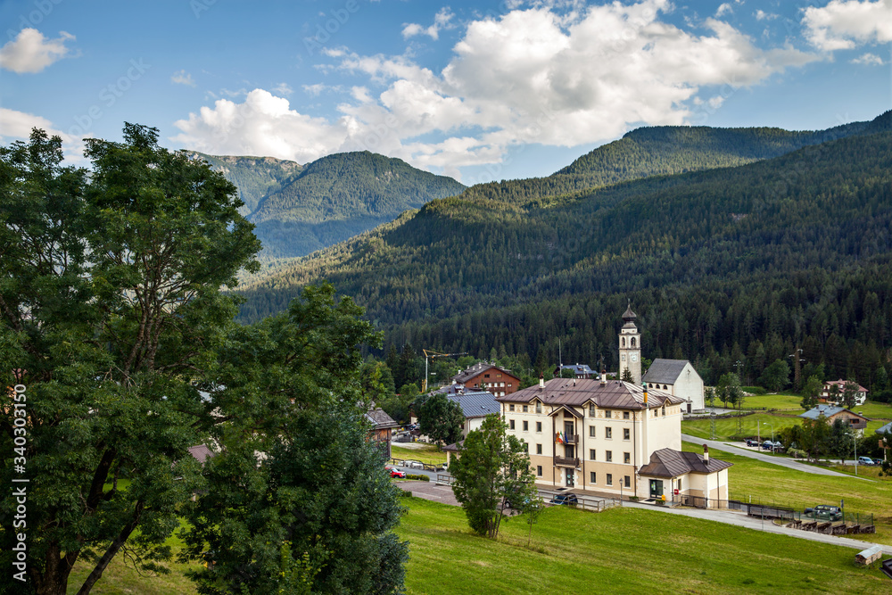 Fototapeta premium Alpine village with town hall and Church in summer