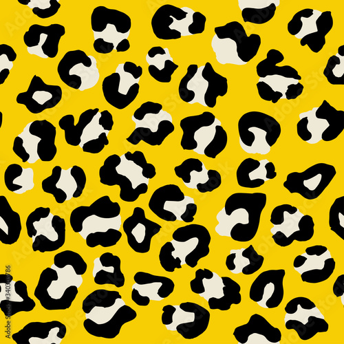 Leopard seamless pattern. Vector animal print. Black and white spots on a yellow background. Jaguar, leopard, cheetah, panther fur. Leopard skin imitation can be painted on clothes or fabric.