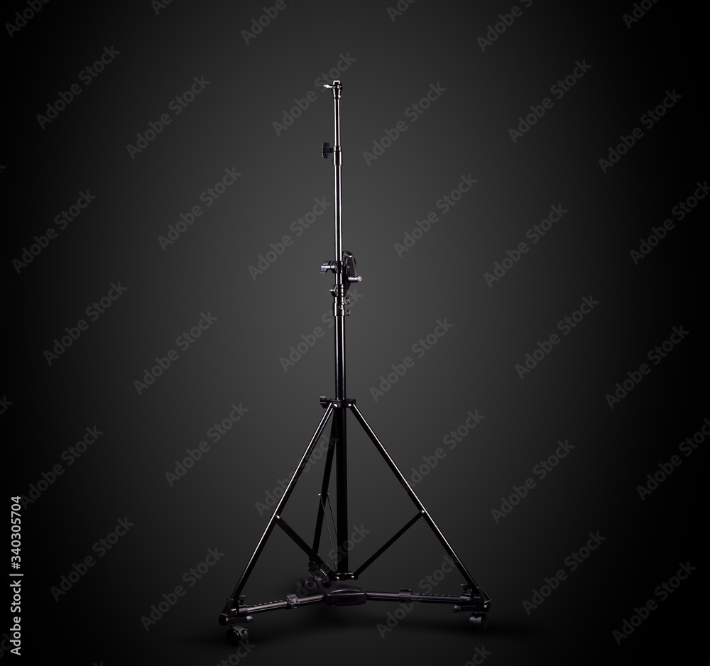 Photo studio lighting stands isolated on the black background. Photo studio lighting stands isolated on the black background.