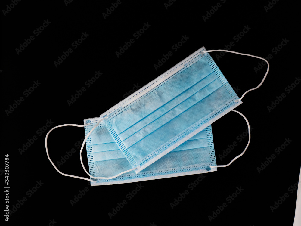 Two Medcine Face masks on black background. Mask to prevent Covid-19 virus or coronavirus. Two Medcine Face masks on black background. Mask to prevent Covid-19 virus or coronavirus.