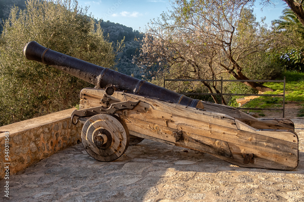 Ancient weapons. war cannon. Large wooden wheels