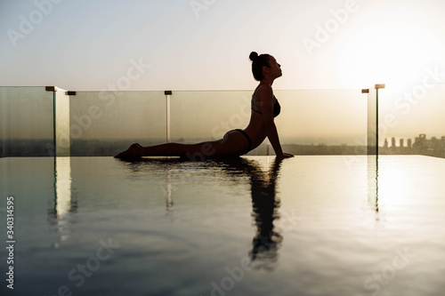 Photography Portrait of gorgeous young woman practicing yoga outdoor