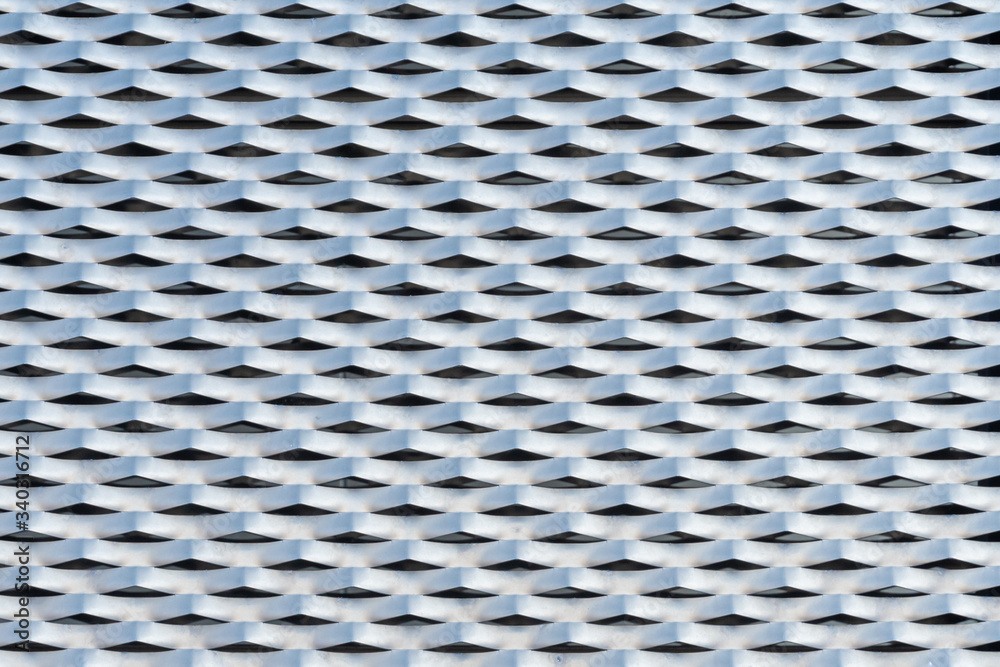 Building facade cladded with punched and perforated metal plates texture Building facade cladded with punched and perforated metal plates texture