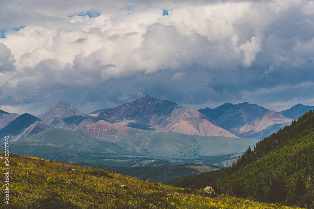 silhouette of mountain range in haze on horizon in mountain valley. Hiking in wild silhouette of mountain range in haze on horizon in mountain valley. Hiking in wild