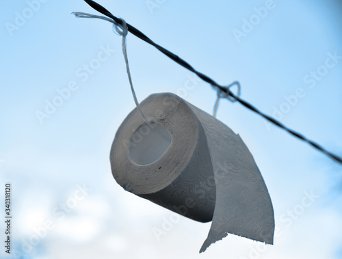 roll of toilet paper hanging on a rope
