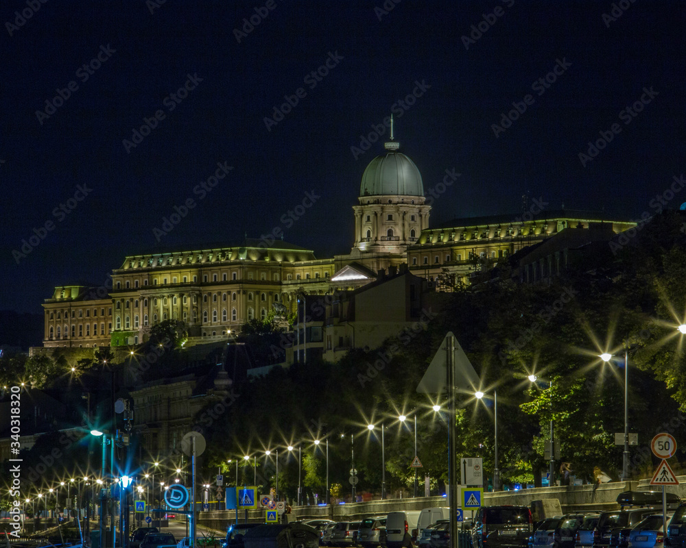 Buda Castle overlooking the Danube River and the lighted streets below in Budapest, Hungary