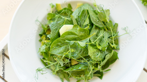 Green salad with arugula and broccoli in a plate with