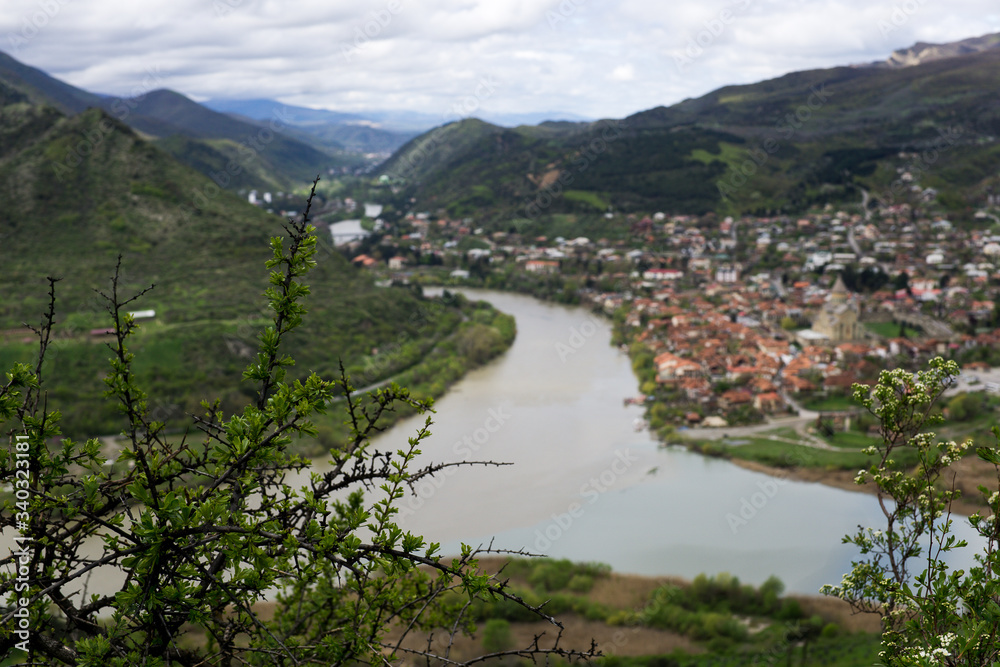 confluence of two rivers in the mountainous part of Georgia. The merging of the Kura and Aragvi. The top view of Mtskheta, Georgia. The historical town lies at the confluence of the rivers 