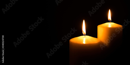 Flame candles isolated on black background. Close up. Copy space.