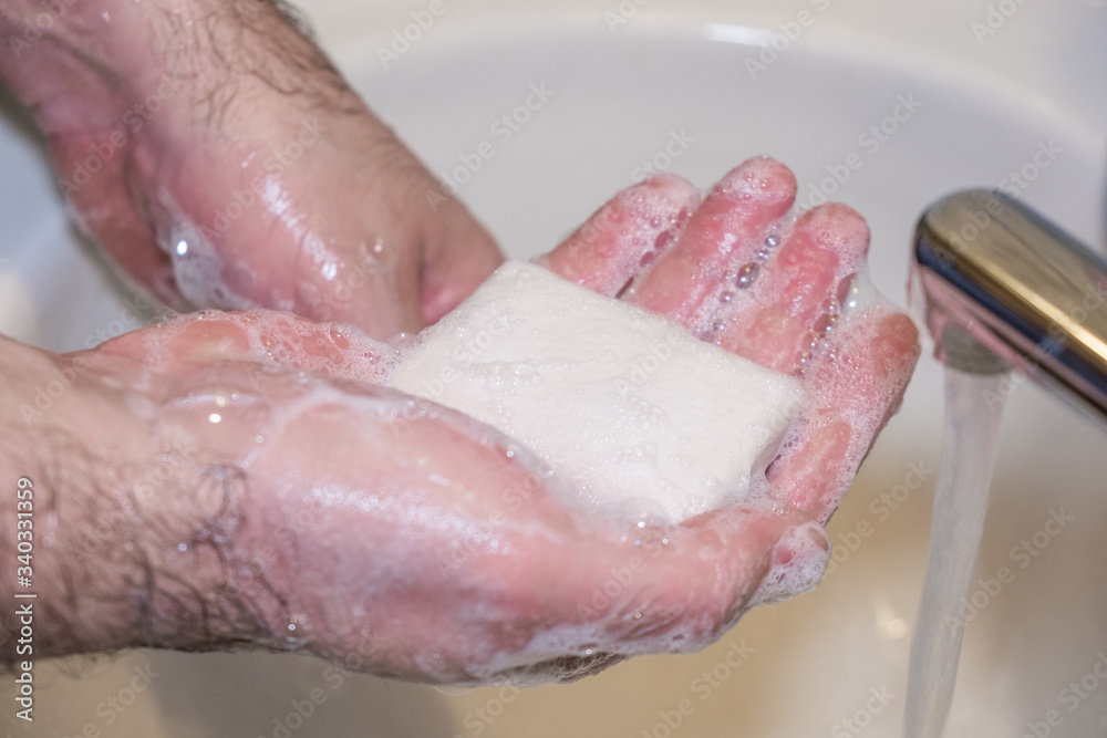 Personal hygiene and prevention of the coronavirus pandemic wash men's hands with soap and water. Personal hygiene and prevention of the coronavirus pandemic wash men's hands with soap and water.