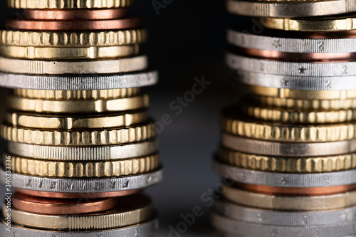 Two stacked Euro coin towers next to each other with dark Background