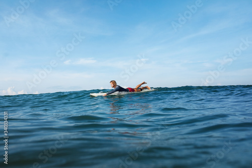 Surfing. Handsome Surfer In Wetsuit On Surfboard. Portrait of Man Swimming In Ocean. Waved Water Surface, Water Sport Livestyle 