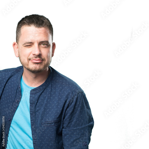 Young man wearing a blue outfit. Blinking eye.