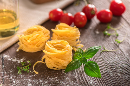 Raw ingredients for cooking pasta on rustic background