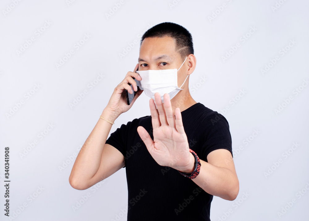 Asian man portrait wearing mask for protect pm2.5 and show stop hands gesture for Covid-19 Asian man portrait wearing mask for protect pm2.5 and show stop hands gesture for Covid-19