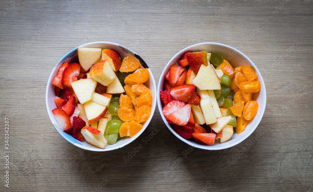 Fruit bowl: Strawberries, apple chunks, grapes and tangerines in a bowl Fruit bowl: Strawberries, apple chunks, grapes and tangerines in a bowl