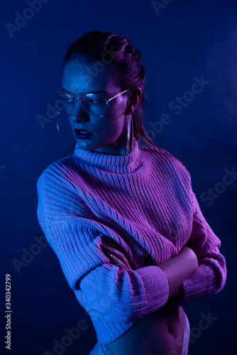 Woman in neon light dancing in the club
