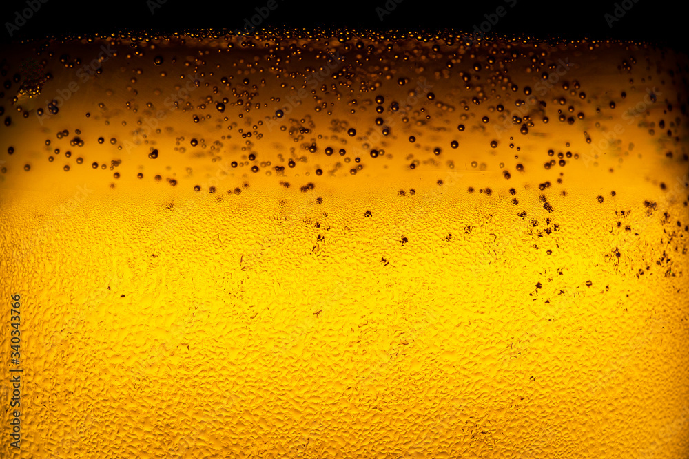 Close up of water drop on glass of beer background,Dewy beer glass bottle texture