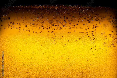 Close up of water drop on glass of beer background Dewy beer glass bottle texture