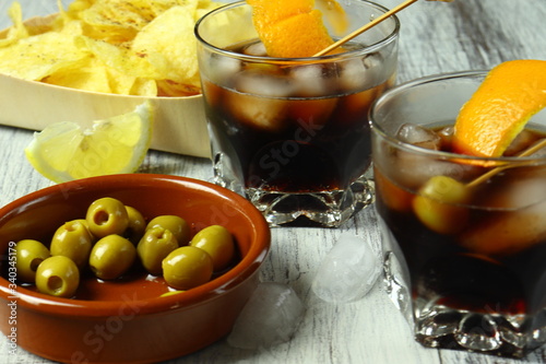 Murais de parede Aperitivo típico español con vermú, aceitunas, patatas fritas con limón y pimien