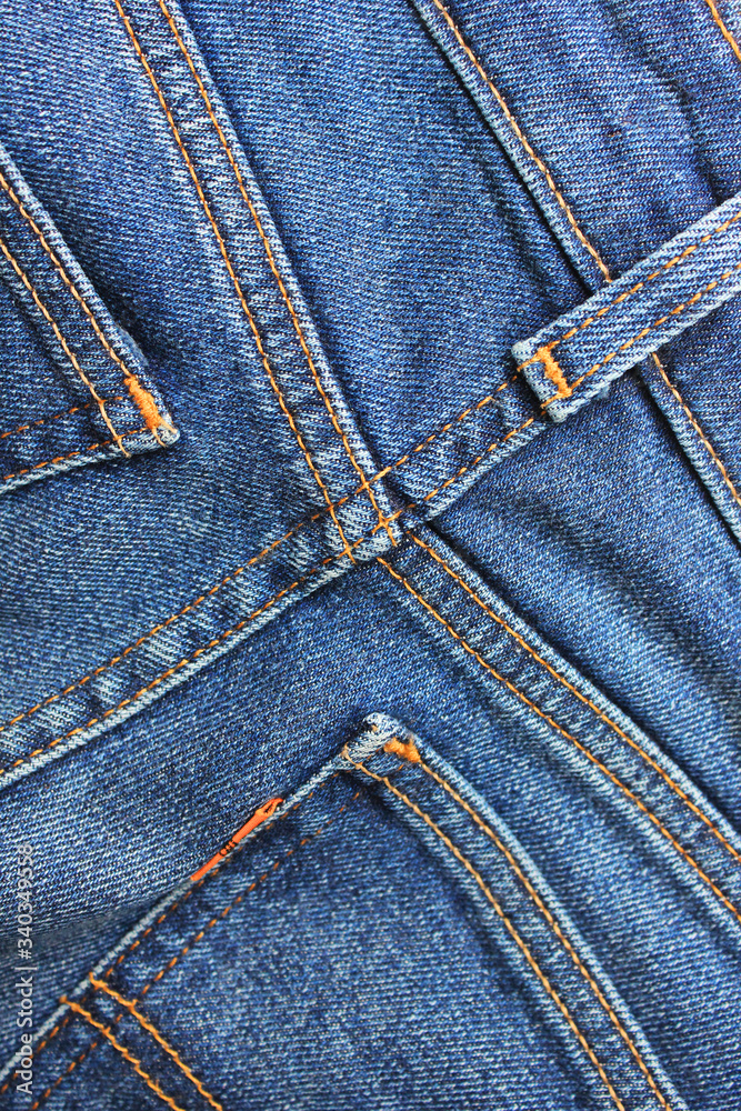 Denim jeans back view. Seams and stitch pattern on stylish denim jean cloth, fragment of casual simple blue jeans. Fashion design detailed wallpaper, classic unisex jeans background Denim jeans back view. Seams and stitch pattern on stylish denim jean cloth, fragment of casual simple blue jeans. Fashion design detailed wallpaper, classic unisex jeans background
