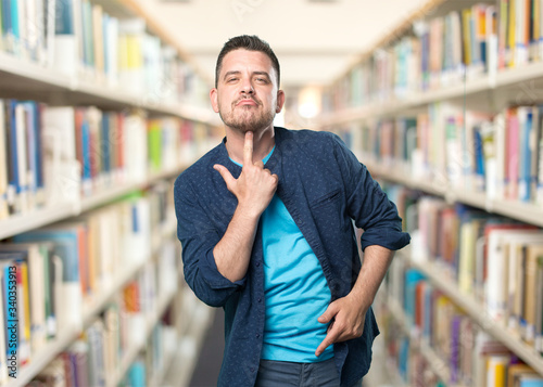 Young man wearing a blue outfit. Doing gun gesture. © borjandreu