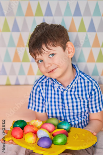 Different color Easter Eggs in a child's hands- egg hunt.