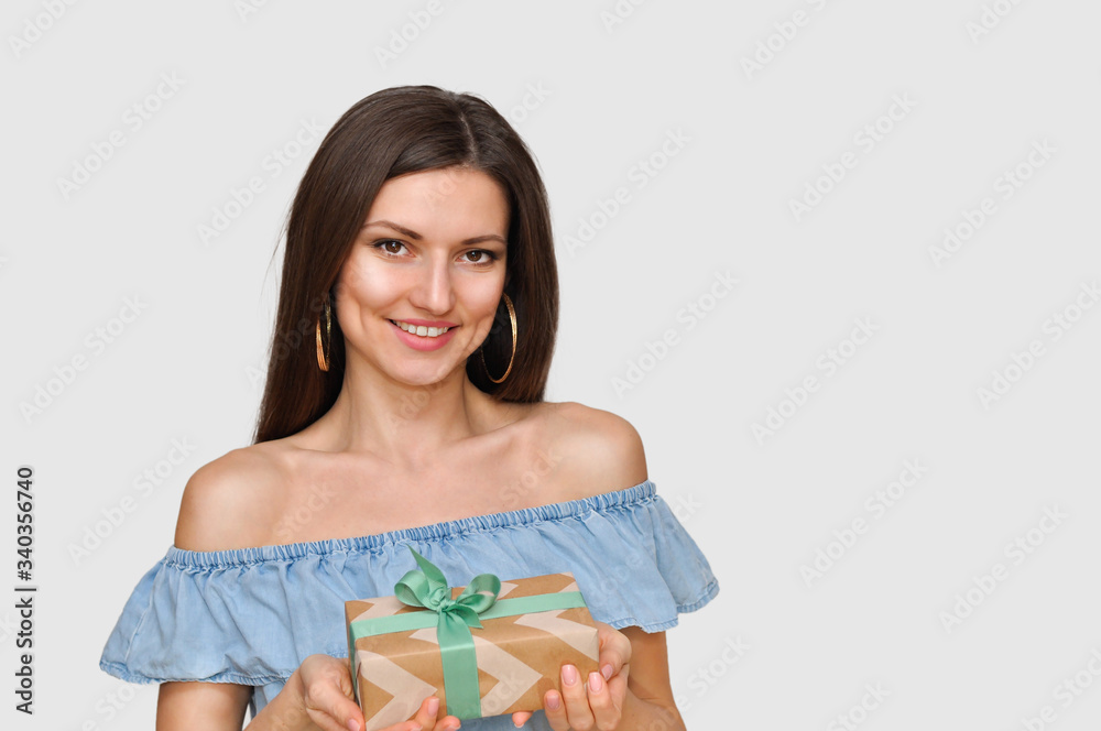 Beautiful smiling sexy woman holds beautiful a gift box in her hands. Beautiful smiling sexy woman holds beautiful a gift box in her hands.