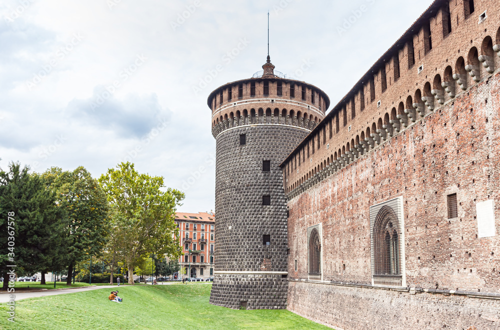 Fragment of the fortress wall and a corner tower of the Sforzesco Castle - Castello Sforzesco in Milan, Italy