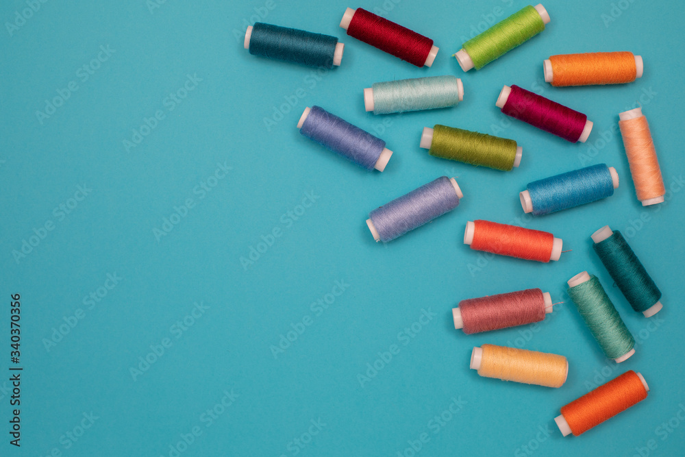Multicolored cotton threads, spools, handmade sewing. Top view with copyspace, flat lay. Multicolored cotton threads, spools, handmade sewing. Top view with copyspace, flat lay.