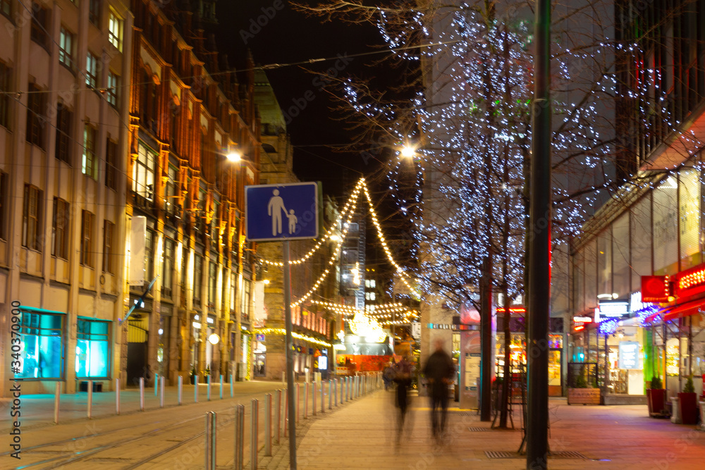 Festive Christmas atmosphere with bright illumination on the central Helsinki street in Finland on Christmas night.