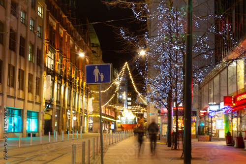 Festive Christmas atmosphere with bright illumination on the central Helsinki street in Finland on Christmas night.