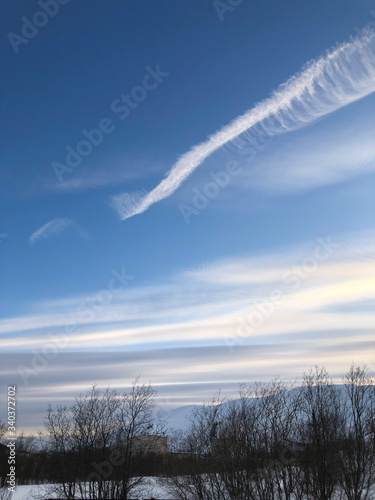 Beautiful blue sky with feather clouds for the background © Kateryna
