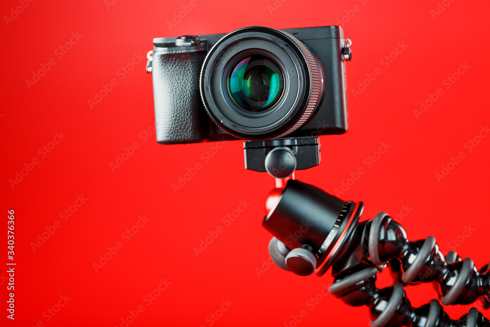 Camera on a red background. Record videos and photos for your blog or report.