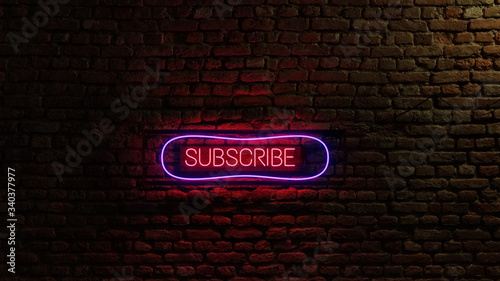 neon subscribe glowing sign with brick wall in background