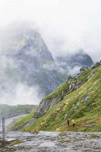 foggy mountains on Lofoten with hikers photo