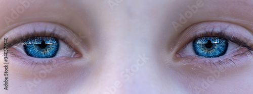 The blue eyes of the child. Photographed close-up.