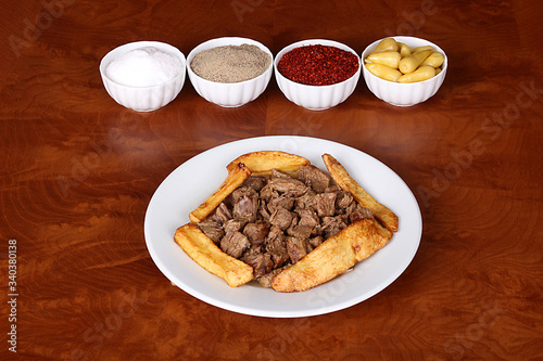 very nice roasted meat with potatoes, turkish spicy on white plate photo